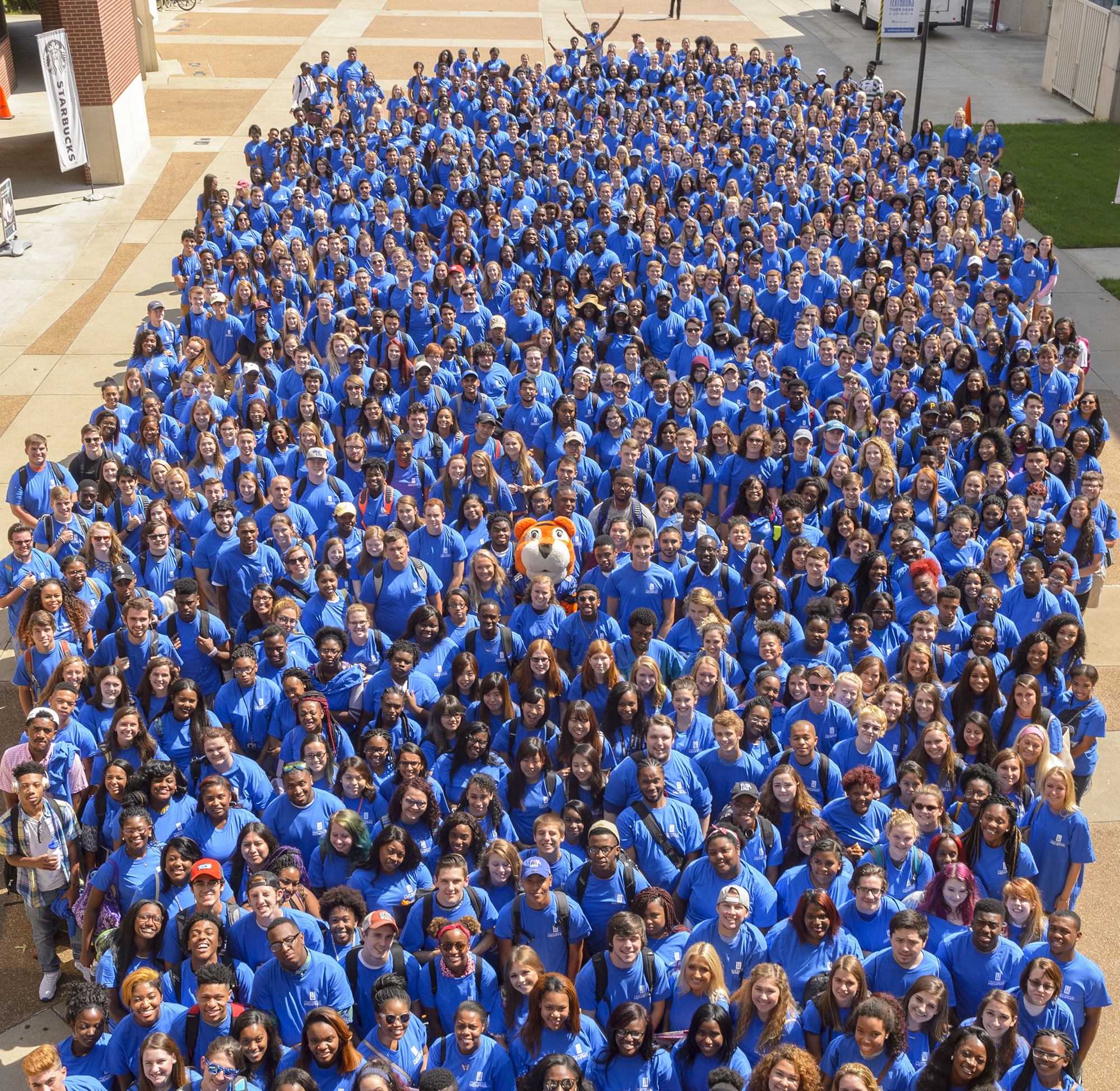 arial shot of large group of students in blue