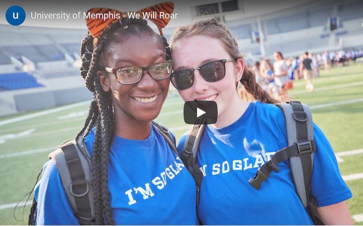 Two students at a football stadium