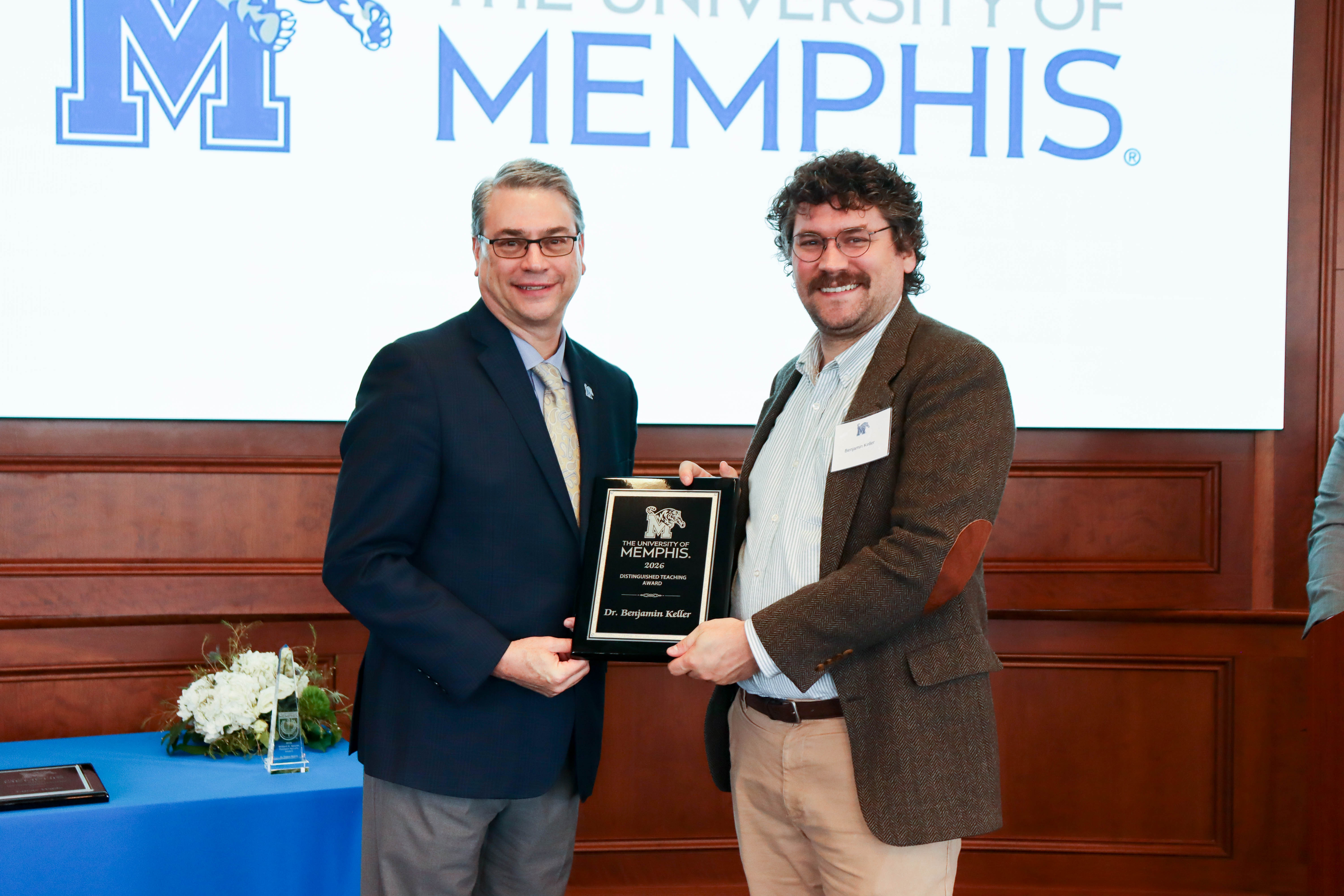 Provost standing with faculty award winner