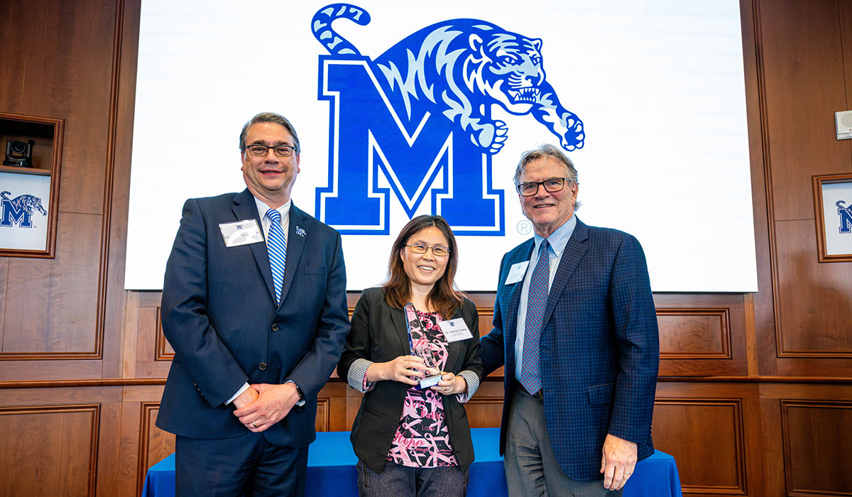 Provost standing with faculty award winner