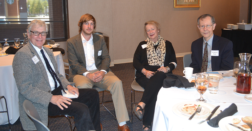 Dean’s Advisory Board members Dr. Tom Gettelfinger, Sandy Riggs and Dr. Webster Riggs and discussing the Travel Enrichment program with student Ben Curtis (second from left).  