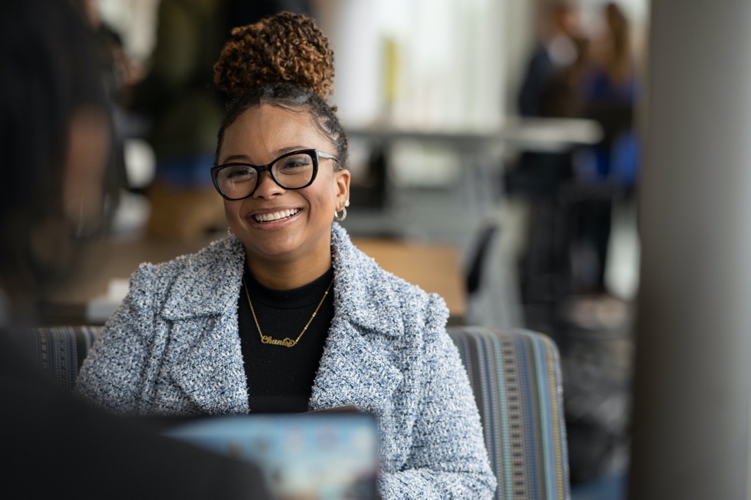 MBA student smiling at fellow classmate