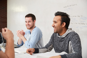 two male students laugh in working group
