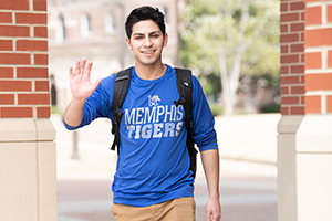 student with backpack and waving