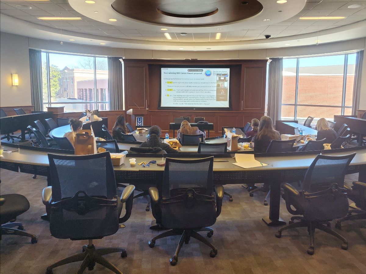 Meeting room with multiple people in it