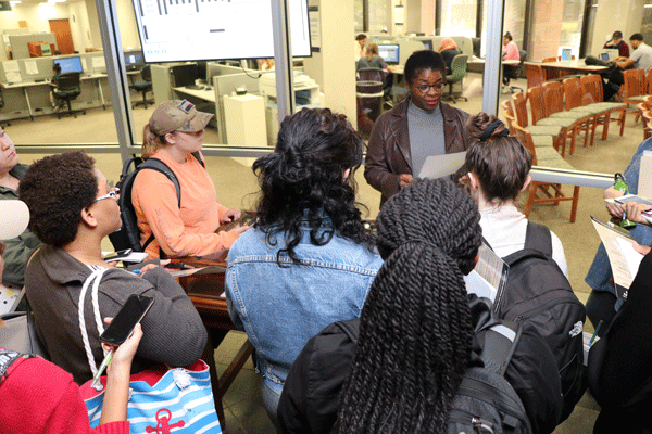 Daphene R. McFerren (Hooks Executive Director) leads a UofM class through the Uplift the Vote Exhibit