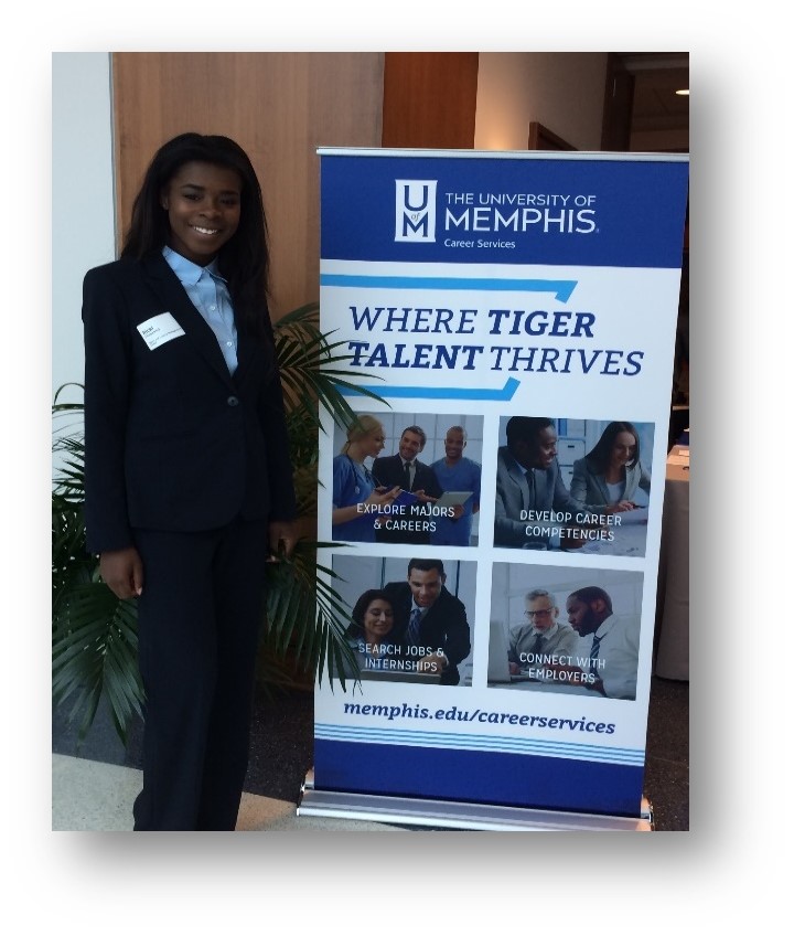 Woman in suit standing in front of Career Services sign