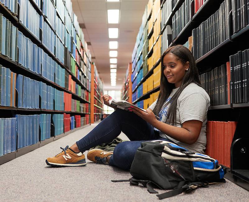 student in library