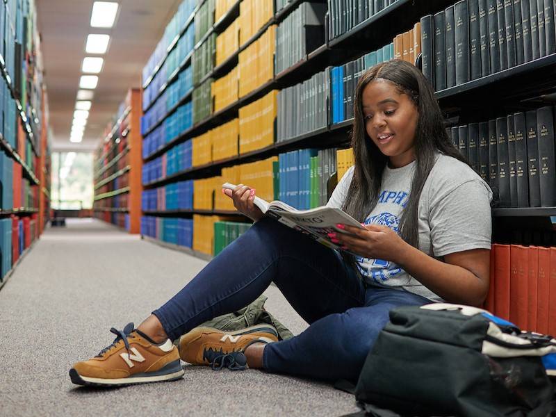 student reading in library