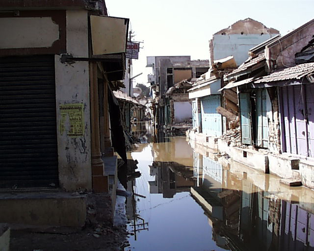 damage and street with water