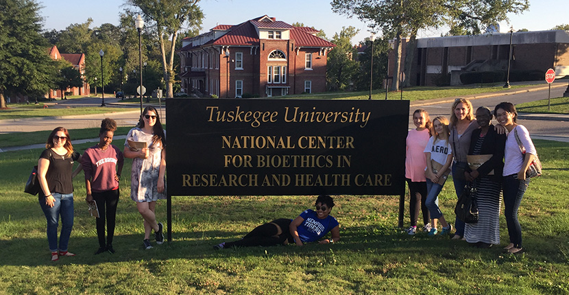 Joy Goldsmith and students outside the National Center for Bioethics in Research and Health Care.