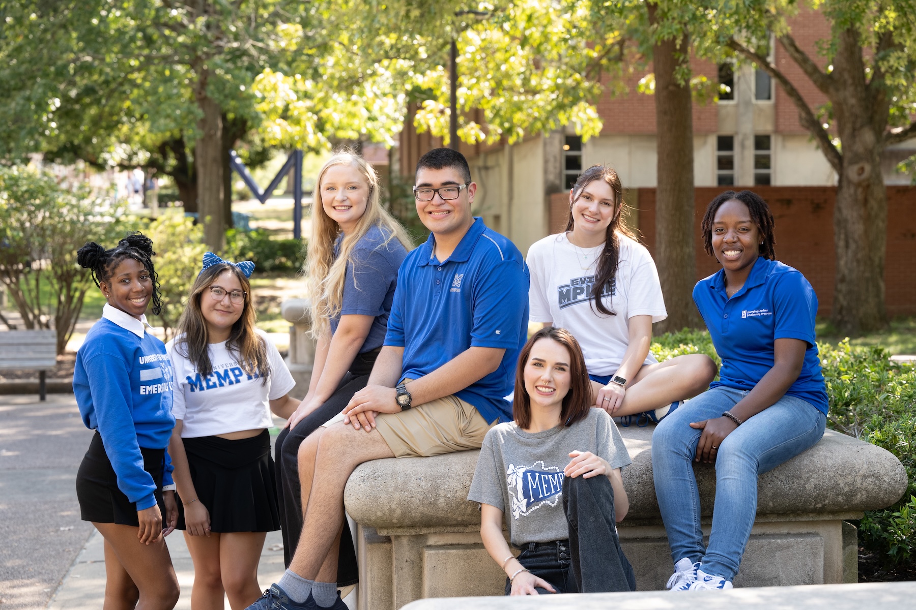 Group of students sitting outdoors smiling