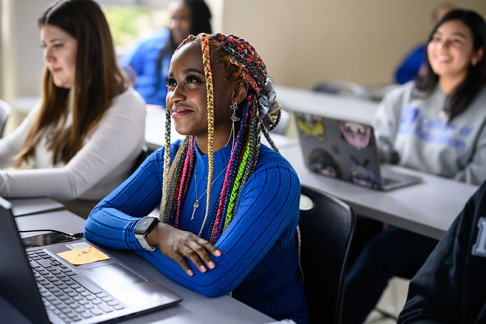 College of Education Student smiling with laptop