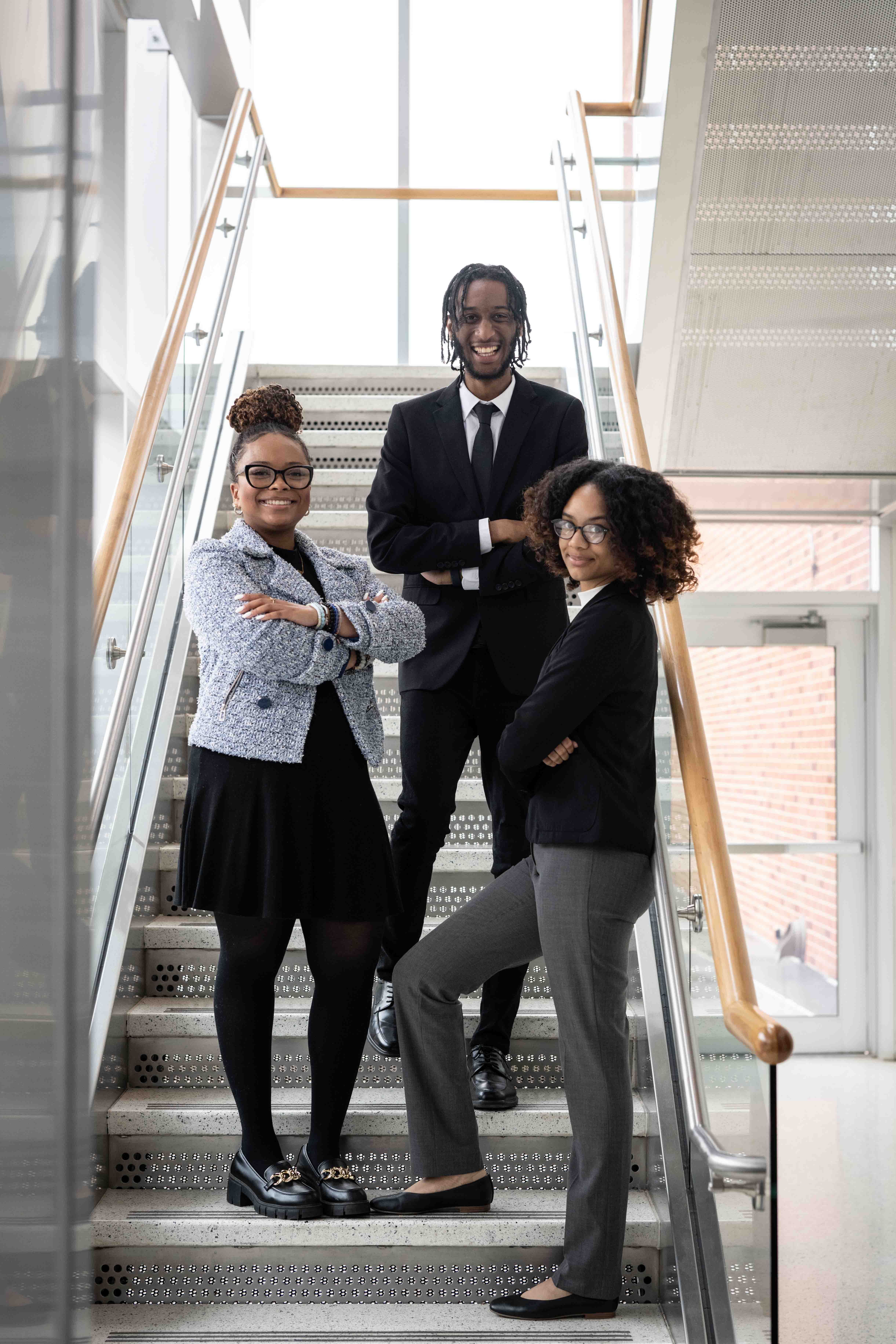 Fogelman college of education MBA students standing on stairs