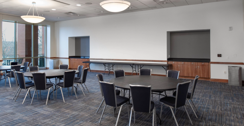 Bluff Room with round tables and view of the back counters