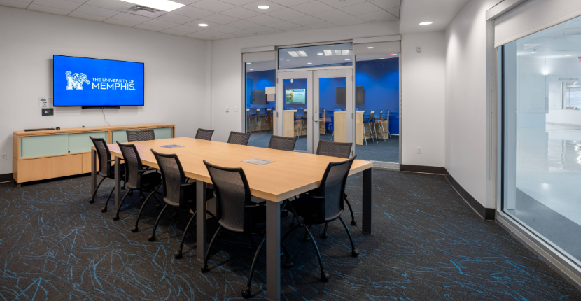 View of Conference Room 203 showing the table and screen