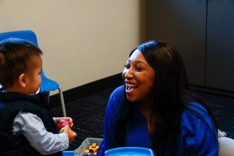 2nd year SLP student Lori Davis interacts with a young client.