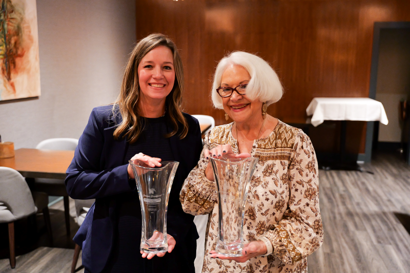 Pat McCaleb and Dr. Jacque Bradford hold awards during the University of Memphis College of Education 2026 Alumni Awards luncheon.