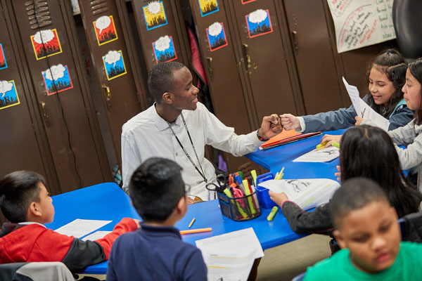 Male Elementary School Teacher with Students