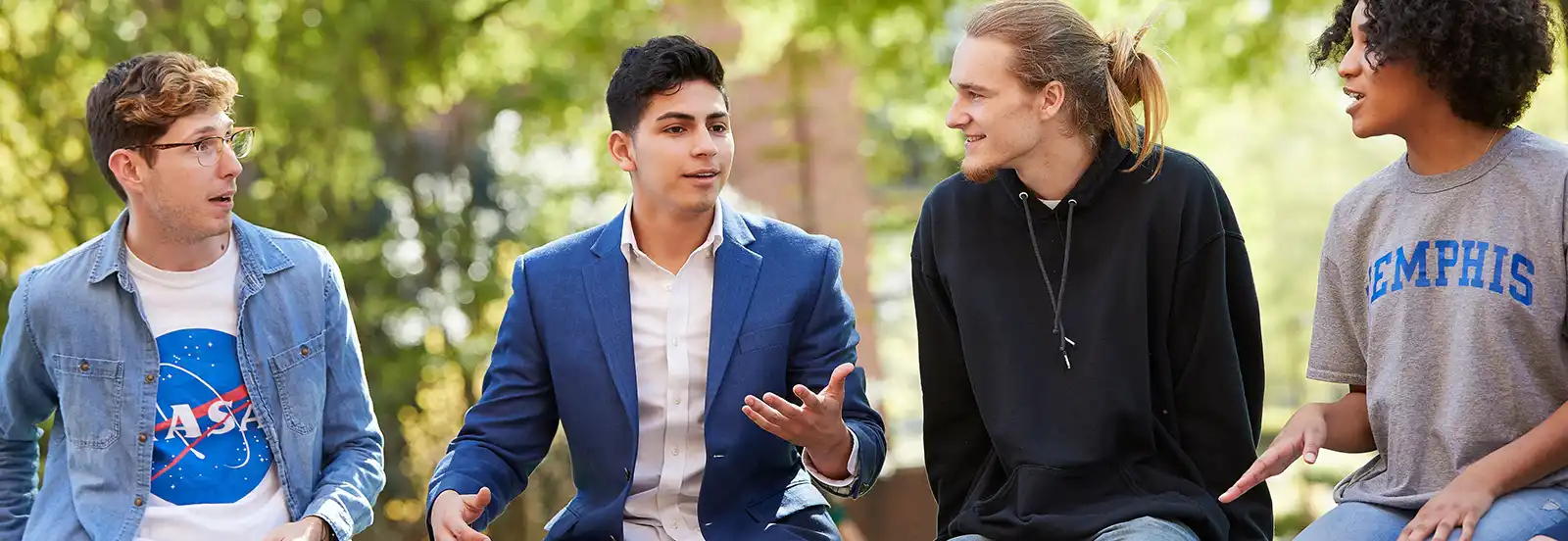 four students talking outside 