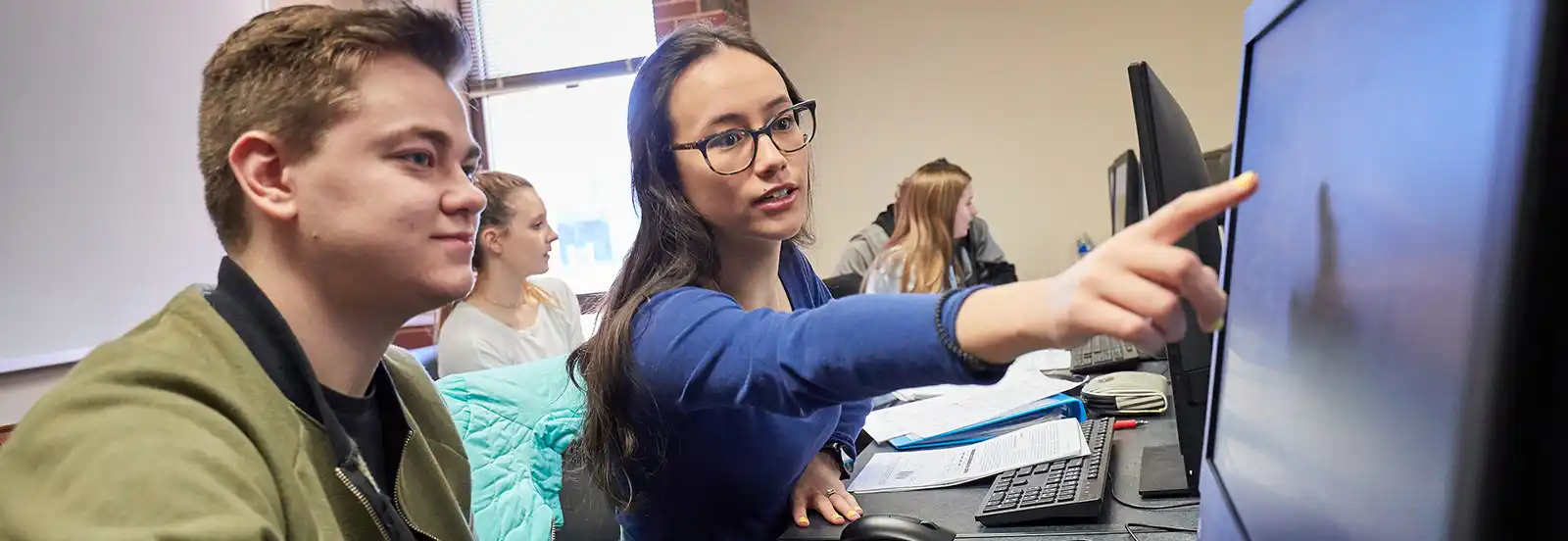 two students looking at a computer