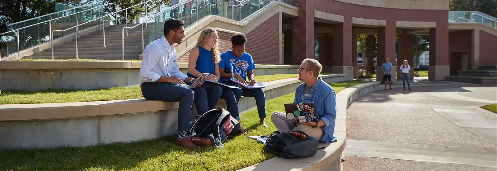 four students talking outside 