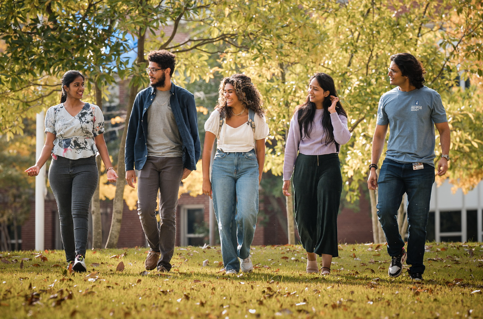 students walking through campus in the fall