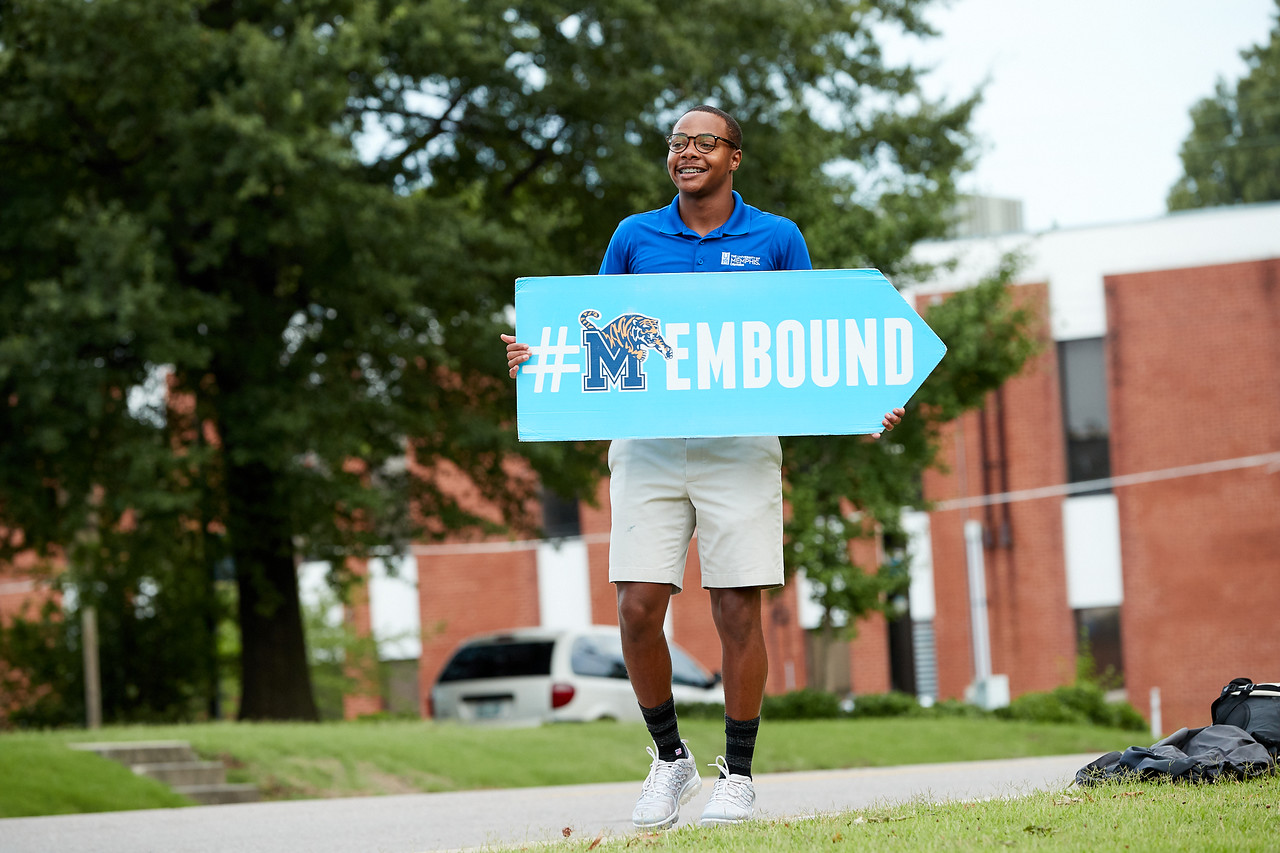 student holding membound sign