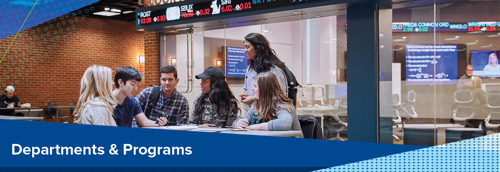 Departments & Programs (image of a group of students collaborating at a table in lobby)