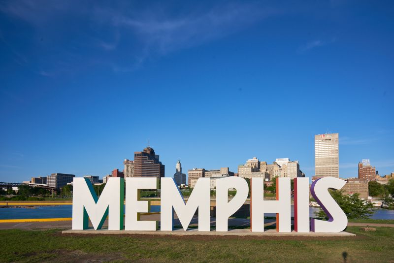 Tiger statute in front of blue fountain
