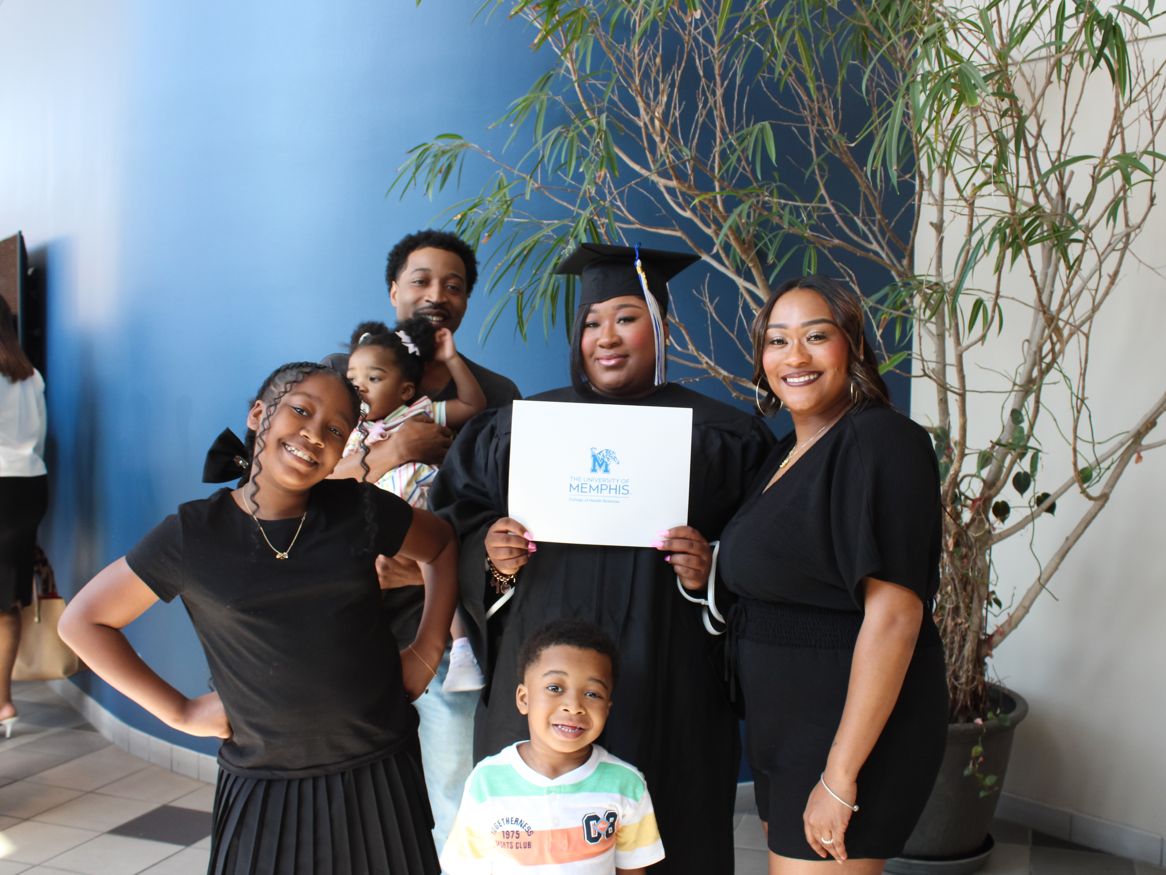 Photo of Graduate Draven Jones and her family at Draven's graduation.