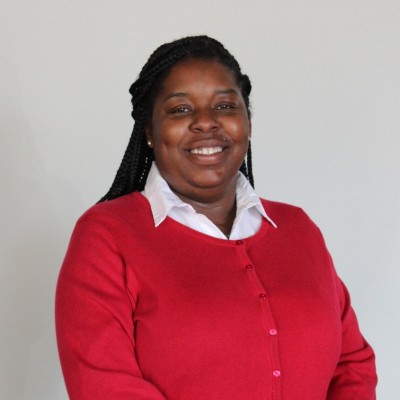 Photo of Trineka Hardrick, black woman wearing a red sweater