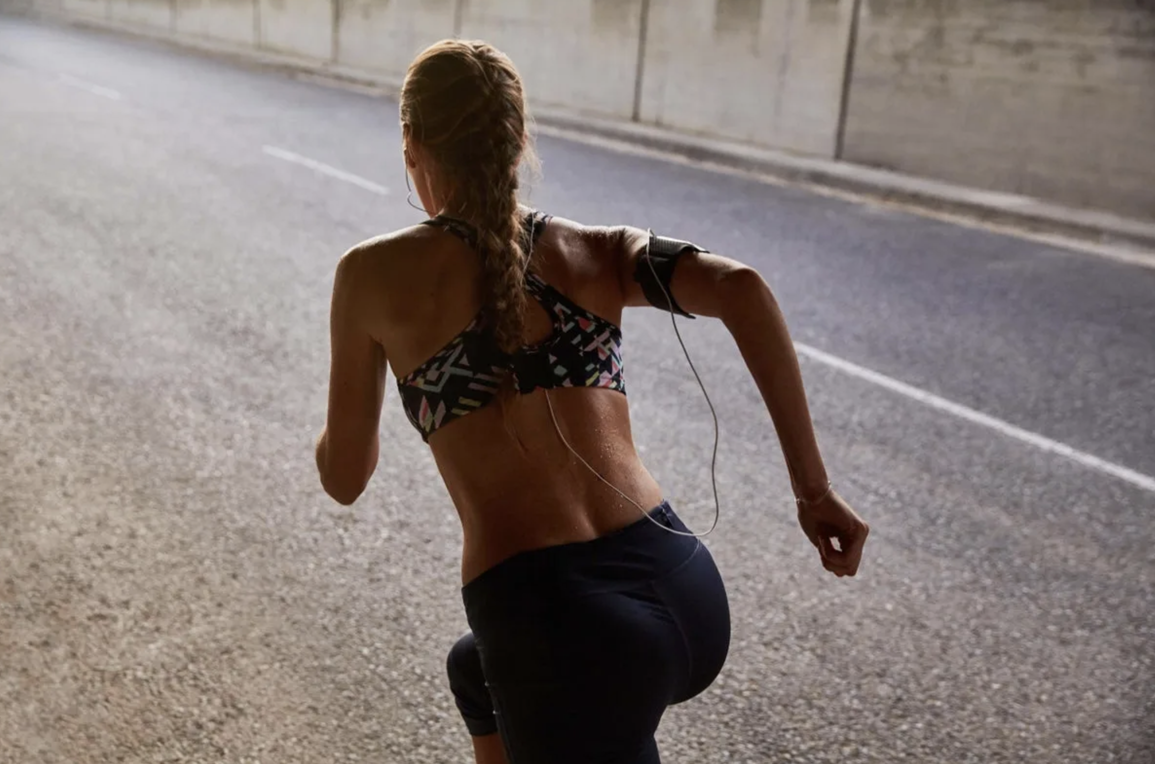 Woman running in a sports bra and shorts