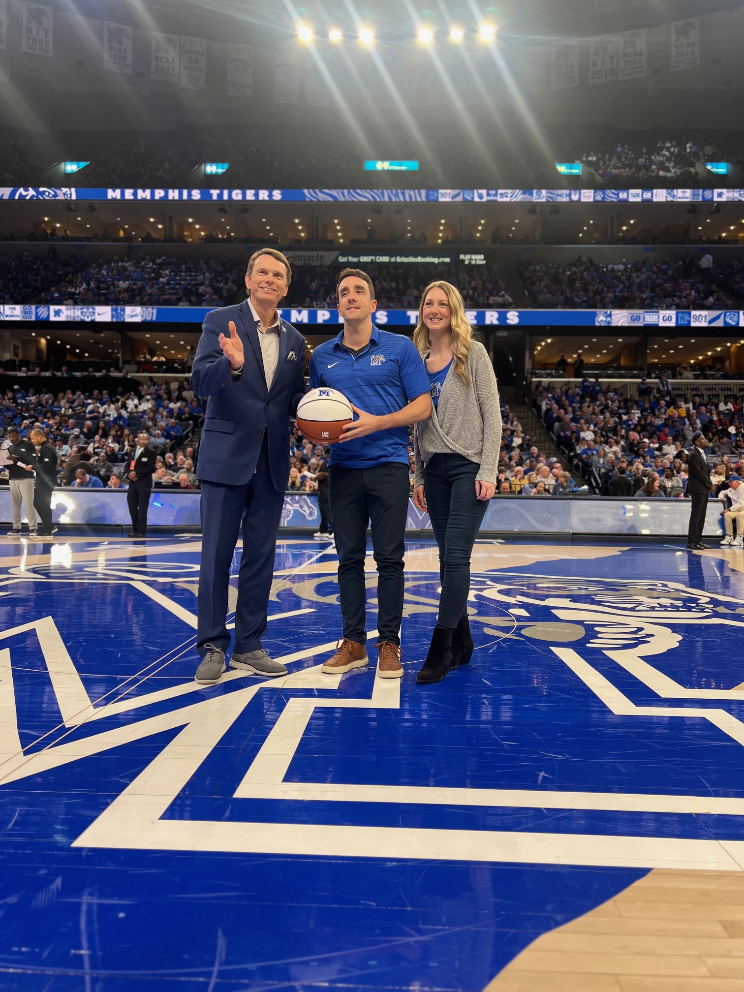 Dr. paquette receiving award on basketball court