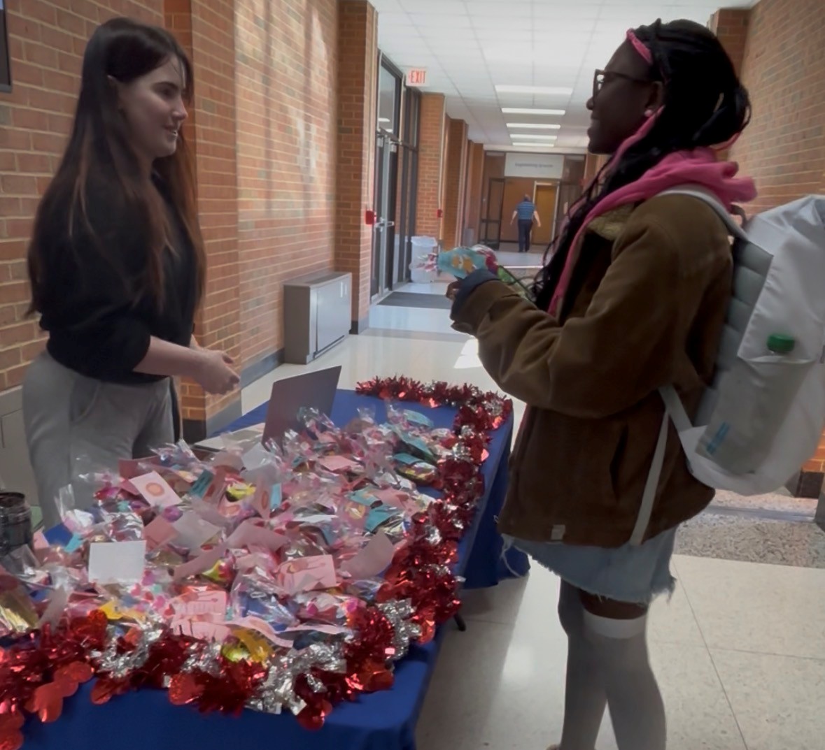 Sophomore biomedical student and SWE member Audrey Alberson (left) hands out a BAE Gram at SWE's annual event. 