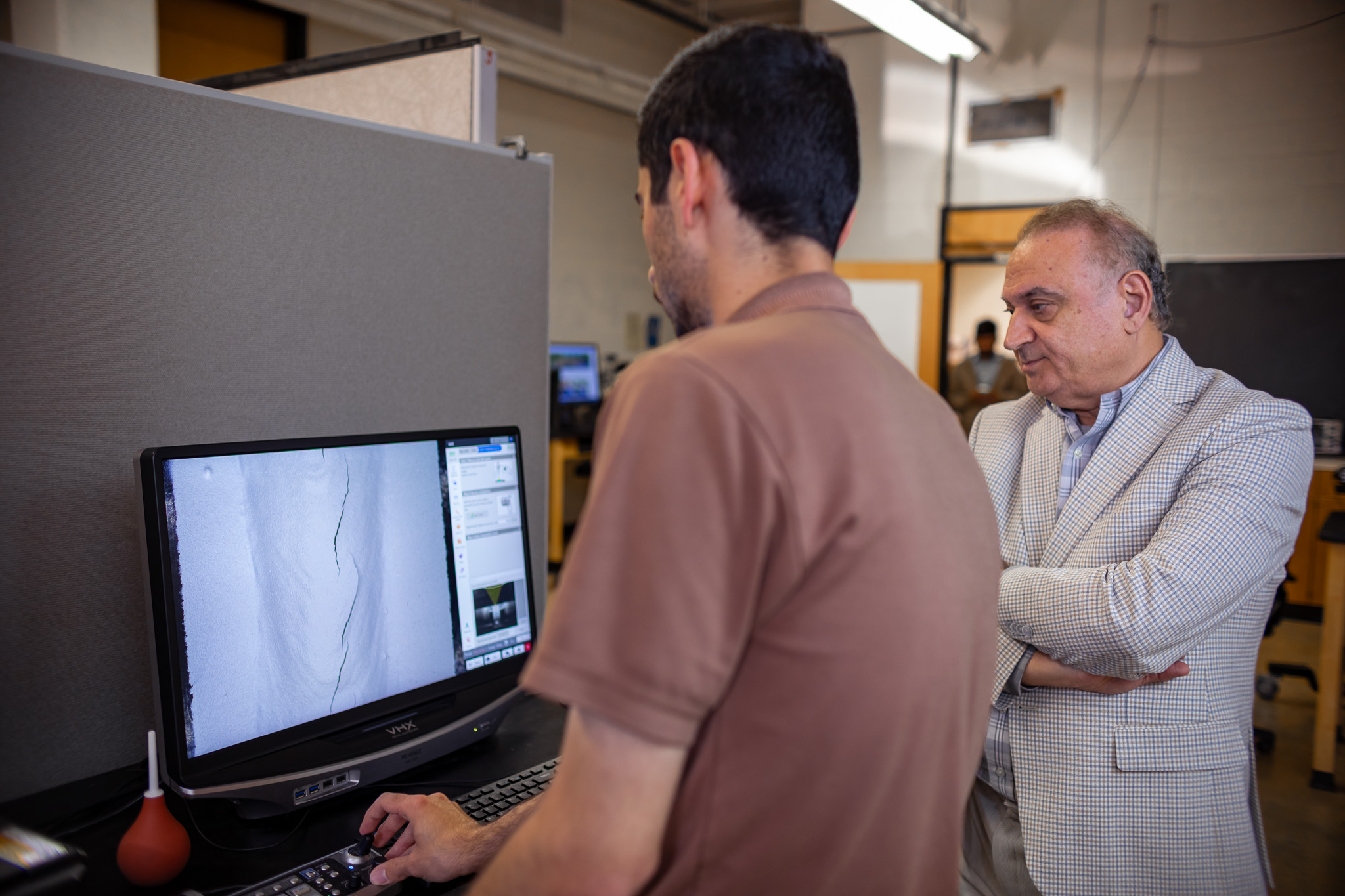 Dr. Fatemi in lab with student