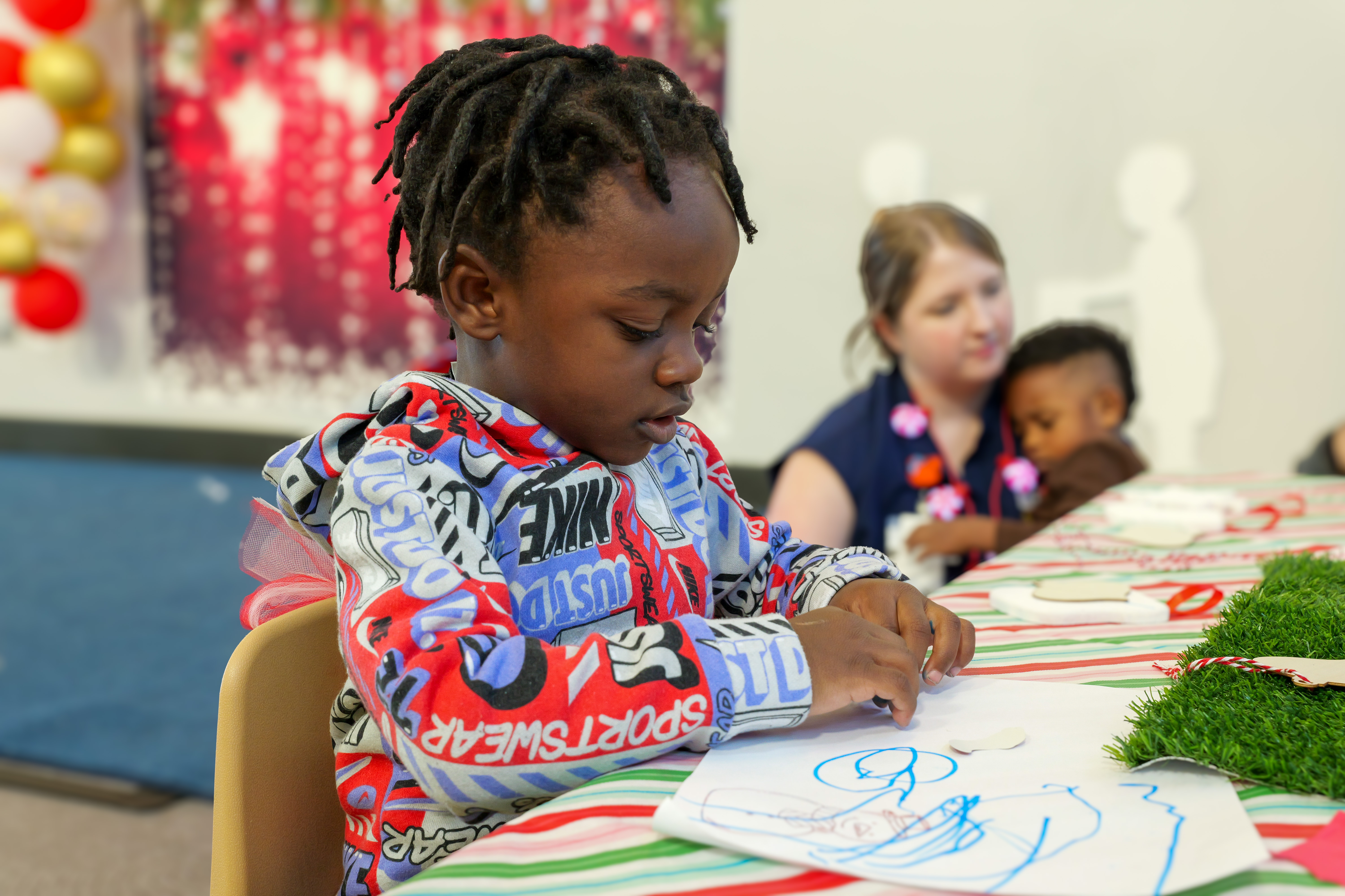 Student coloring at table