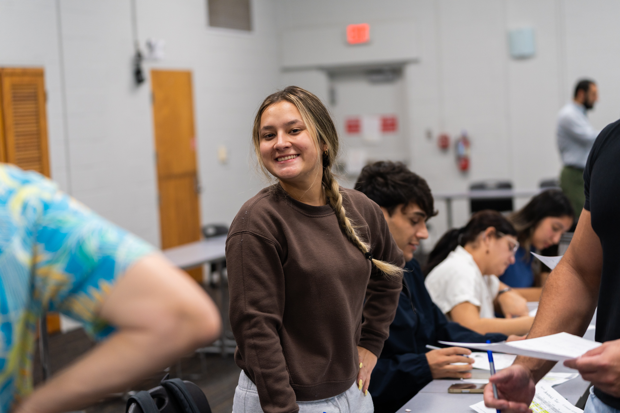 international-student-brown-shirt-smiling-at-the-camera