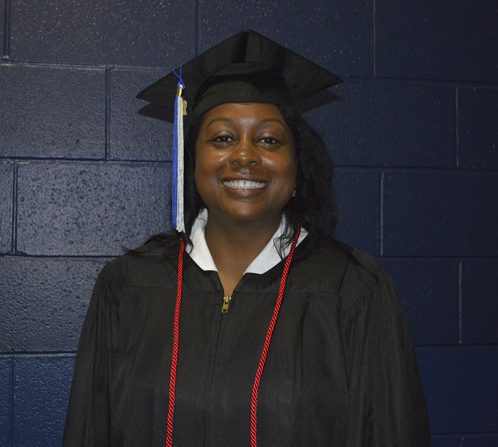 Kimberly smiles with her cap and gown on