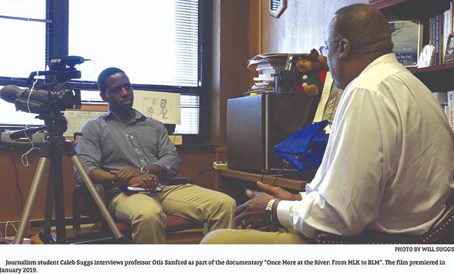 Journalism student Caleb Suggs interviews Prof. Otis Sanford