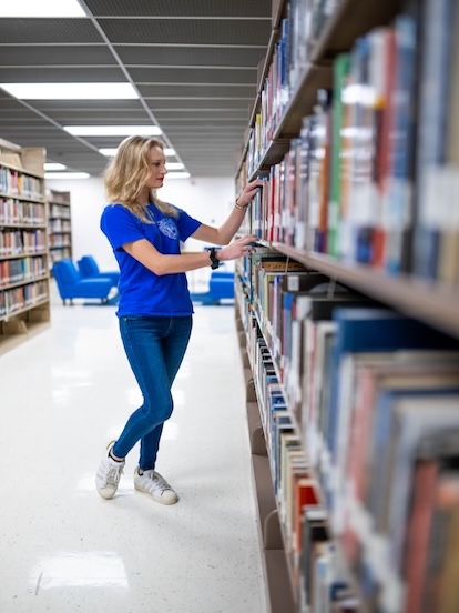 student in library