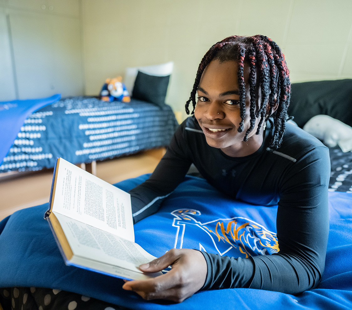 student studying in dorm housing