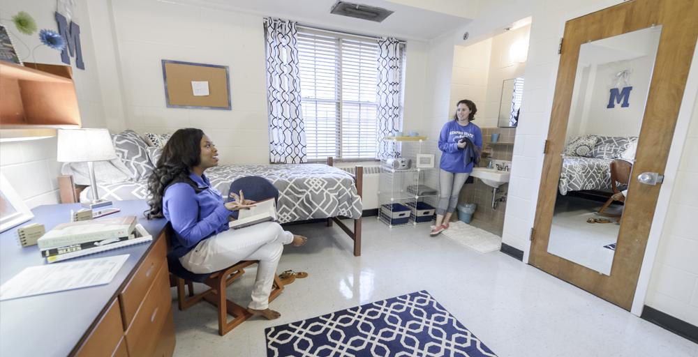 two students talking in their Rawls Hall double bed dorm room