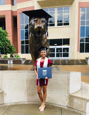 Chanel after graduation with bronze tiger statue