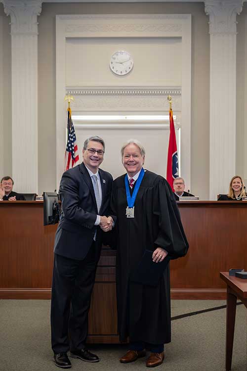 UofM Provost David Russomanno (left) honors Tennessee Supreme Court Justice Roger A. Page