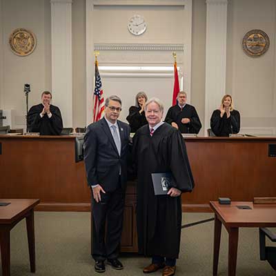 UofM Provost David Russomanno (left) honors Tennessee Supreme Court Justice Roger A. Page. 