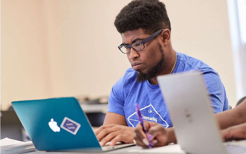 male student working on laptop