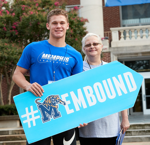 student with parent and #MEMbound sign