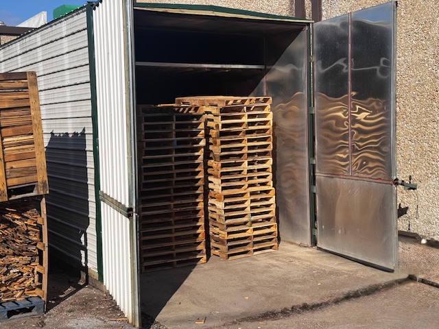 A stack of wooden Pallets outdoors 