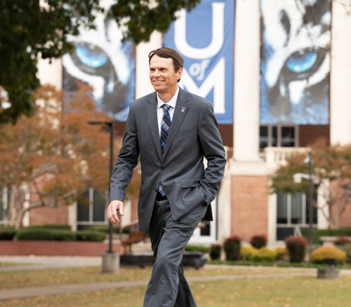 Dr. Hardgrave walking in front of Administration Building